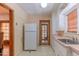 Classic kitchen with a vintage refrigerator and door to the backyard at 1134 W Portland St, Phoenix, AZ 85007
