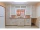 Functional kitchen featuring classic cabinetry, stainless steel sink, and ample counter space at 1134 W Portland St, Phoenix, AZ 85007