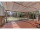 View of the covered patio overlooking a grassy backyard with trees and foliage at 1134 W Portland St, Phoenix, AZ 85007