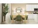 Well lit dining room with modern table, chairs, light fixture and window at 11952 W Calle De Pompas --, Peoria, AZ 85383
