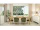 Bright dining room with a natural wood table, modern chairs, and large window at 11952 W Calle De Pompas --, Peoria, AZ 85383