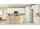 Bright kitchen featuring white cabinets, stainless steel appliances, and center island with seating at 11952 W Calle De Pompas --, Peoria, AZ 85383