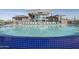 Stunning swimming pool with a blue tiled edge and modern building in the background at 11952 W Calle De Pompas --, Peoria, AZ 85383