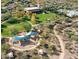 Aerial view of the community park with a playground and covered seating, as well as lush green space at 12118 W Dove Wing Way, Peoria, AZ 85383