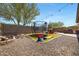 Beautiful backyard complete with a trampoline, playhouse, built-in grill, and string lights at 12118 W Dove Wing Way, Peoria, AZ 85383