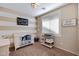 Cozy Bedroom featuring striped walls, white crib, changing table, and a warm, inviting atmosphere at 12118 W Dove Wing Way, Peoria, AZ 85383