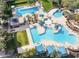 Aerial view of the community pool with lounge chairs, shaded areas, and lush landscaping at 12118 W Dove Wing Way, Peoria, AZ 85383
