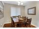 Formal dining room featuring a large table with seating for eight and a large window at 12118 W Dove Wing Way, Peoria, AZ 85383