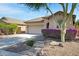 This home features desert landscaping, mature trees, tile roof, and a two-car garage at 12118 W Dove Wing Way, Peoria, AZ 85383