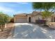 Charming single-Gathering home showcasing a well-manicured lawn, mature trees, and a two-car garage at 12118 W Dove Wing Way, Peoria, AZ 85383