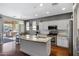 Modern kitchen features granite countertops, stainless steel appliances and large island with sink at 12118 W Dove Wing Way, Peoria, AZ 85383