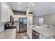 Well-lit kitchen featuring granite countertops, stainless steel appliances, and convenient access to living area at 12118 W Dove Wing Way, Peoria, AZ 85383