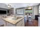 Open kitchen with granite countertops, stainless steel dishwasher, and adjacent view of the backyard patio at 12118 W Dove Wing Way, Peoria, AZ 85383