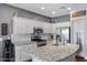 Bright kitchen with stainless steel appliances, granite countertops, and white cabinets for a modern look at 12118 W Dove Wing Way, Peoria, AZ 85383