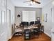 Well-lit home office with dual workstations, wood floors, and a neutral color palette at 12118 W Dove Wing Way, Peoria, AZ 85383