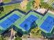 Aerial view of the community tennis courts with lush landscaping and professional lighting at 12118 W Dove Wing Way, Peoria, AZ 85383