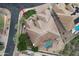 Aerial view of house featuring swimming pool, water feature, green space, outdoor seating and desert landscaping at 136 E Desert Wind Dr, Phoenix, AZ 85048