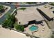 Expansive aerial view of the desert home featuring a private pool, lush landscaping, and a cozy outdoor seating area at 136 E Desert Wind Dr, Phoenix, AZ 85048