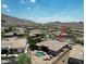 Scenic aerial shot showcases this charming desert home with a sparkling pool nestled amid stunning mountain views at 136 E Desert Wind Dr, Phoenix, AZ 85048