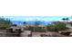Charming backyard with a stone fireplace and built-in seating, offering stunning mountain views and desert landscaping at 136 E Desert Wind Dr, Phoenix, AZ 85048