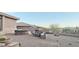 Wide view of the backyard featuring outdoor kitchen, stone fireplace with seating, all within a brick paved patio at 136 E Desert Wind Dr, Phoenix, AZ 85048