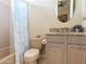 Cozy bathroom featuring a tub with shower, granite counters and stylish fixtures at 136 E Desert Wind Dr, Phoenix, AZ 85048
