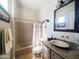 Cozy bathroom featuring a tub with shower, granite counters and stylish fixtures at 136 E Desert Wind Dr, Phoenix, AZ 85048