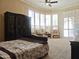 Bedroom features large windows, plush carpet, and elegant furniture for a tranquil space at 136 E Desert Wind Dr, Phoenix, AZ 85048