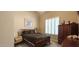 Well-lit bedroom with bed and matching furniture, a window with shutters, and neutral colored walls at 136 E Desert Wind Dr, Phoenix, AZ 85048