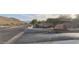 Street view of the Whistling Rock community entrance with desert landscaping and mountain views at 136 E Desert Wind Dr, Phoenix, AZ 85048