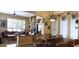Inviting dining area with wood table and chairs adjacent to a cozy living space with stone fireplace at 136 E Desert Wind Dr, Phoenix, AZ 85048