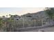 Beautiful hillside home with fence and lush desert vegetation surrounding the property at 136 E Desert Wind Dr, Phoenix, AZ 85048