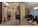 A well-lit hallway with arched doorways leads to a spacious living area with elegant furniture at 136 E Desert Wind Dr, Phoenix, AZ 85048