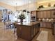 Open-concept kitchen with granite island, modern lighting, and cabinetry adjacent to the dining area at 136 E Desert Wind Dr, Phoenix, AZ 85048