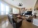 Cozy living room with a stone fireplace, large windows, and comfortable seating arrangement at 136 E Desert Wind Dr, Phoenix, AZ 85048