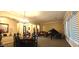Elegant dining room and living room featuring sophisticated decor, a grand piano, and ample natural light at 136 E Desert Wind Dr, Phoenix, AZ 85048