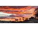 Scenic view of mountain landscape with a dramatic sunset over the Phoenix Mountain Preserve with palm trees in the foreground at 136 E Desert Wind Dr, Phoenix, AZ 85048