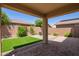 Spacious backyard offers a covered patio and comfortable seating area for entertaining or relaxation at 14180 W Willow Ave, Surprise, AZ 85379