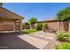 Private backyard featuring a covered patio, low-maintenance landscaping, and tranquil seating area at 14180 W Willow Ave, Surprise, AZ 85379