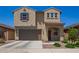 Charming two-story home featuring neutral stucco, a two-car garage, and a well-manicured front yard at 14180 W Willow Ave, Surprise, AZ 85379
