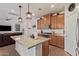 Spacious kitchen featuring a large island, granite countertops, and modern pendant lighting at 14180 W Willow Ave, Surprise, AZ 85379
