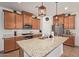 A gourmet kitchen showcasing a large island, granite countertops, stainless appliances, and ample cabinet space at 14180 W Willow Ave, Surprise, AZ 85379