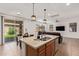 Open kitchen featuring granite countertops, stainless steel appliances, and a large island at 14180 W Willow Ave, Surprise, AZ 85379