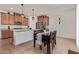 Well-lit kitchen with granite countertops, stainless steel appliances, and a stylish dining set at 14180 W Willow Ave, Surprise, AZ 85379