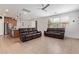 An open-concept living room and kitchen with neutral tile floors and recessed lighting at 14180 W Willow Ave, Surprise, AZ 85379