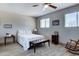 Comfortable bedroom featuring a queen-sized bed and a cozy sitting area with a wooden rocking chair at 14404 N Boxwood Ln, Fountain Hills, AZ 85268