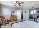 Bright bedroom featuring ceiling fan, wood floors, rocking chair and ample natural light at 14404 N Boxwood Ln, Fountain Hills, AZ 85268
