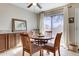Dining area with a wood table, four chairs, and sliding glass doors leading to the outside at 14404 N Boxwood Ln, Fountain Hills, AZ 85268