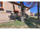 Charming home featuring a well-maintained lawn, desert landscaping, and a front entrance with a red tile awning at 14404 N Boxwood Ln, Fountain Hills, AZ 85268