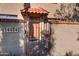 Close-up of the front entrance with a red tile awning, decorative iron gate, and clearly marked address at 14404 N Boxwood Ln, Fountain Hills, AZ 85268